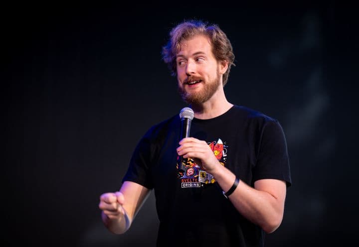 a man holding a microphone in his right hand