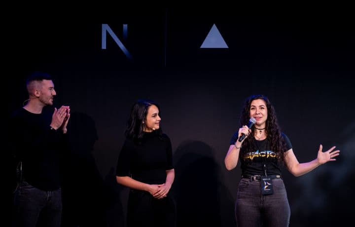 three people standing in front of a microphone