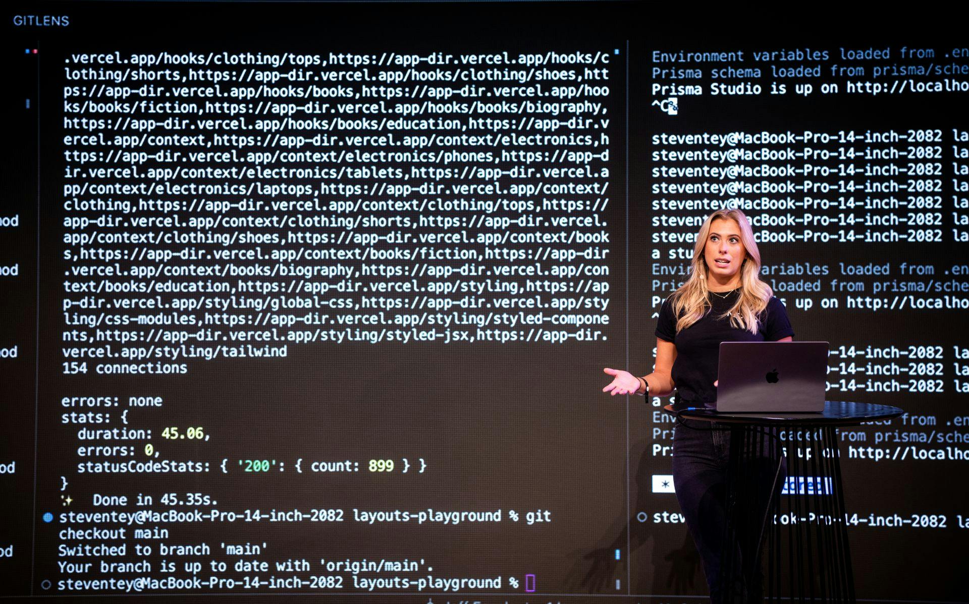 a woman standing at a podium with a laptop