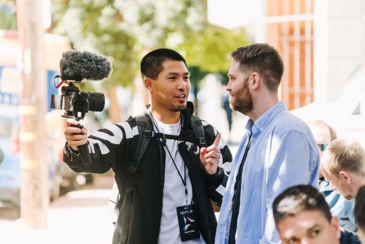 a man holding a camera and a microphone