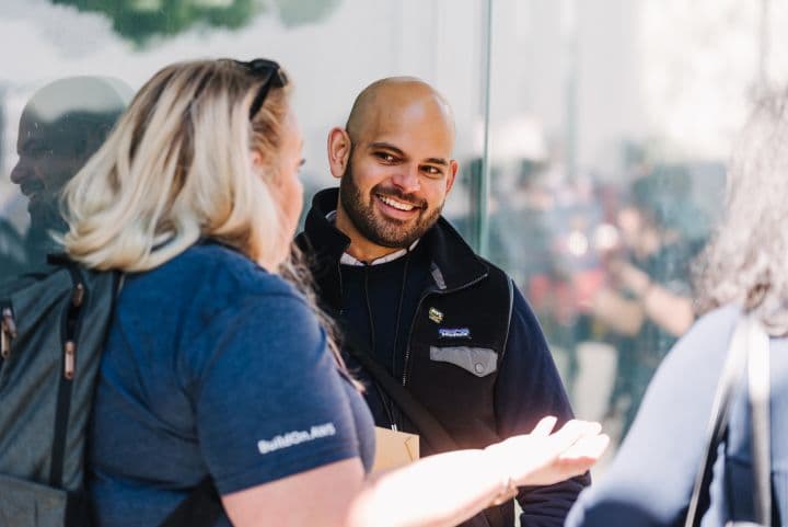 a man talking to a woman in front of a building