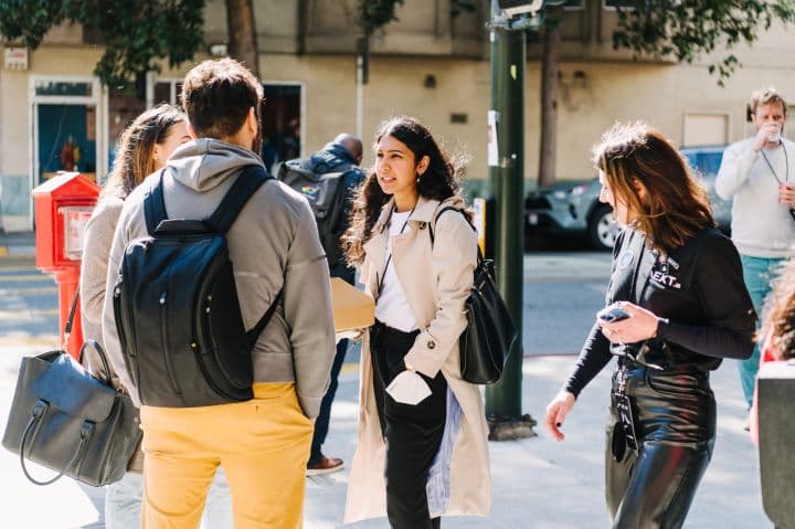 a group of people standing on a sidewalk