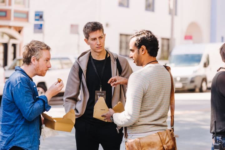 a group of three men standing next to each other