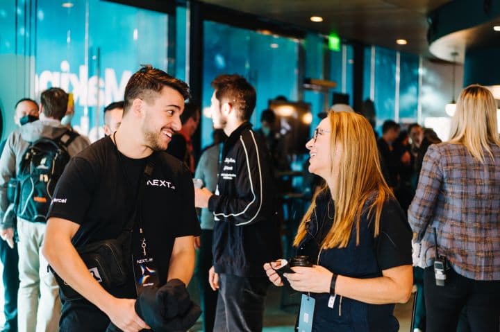 a group of people standing around talking to each other