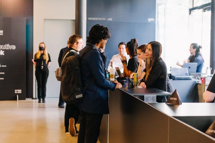 a group of people standing around a counter