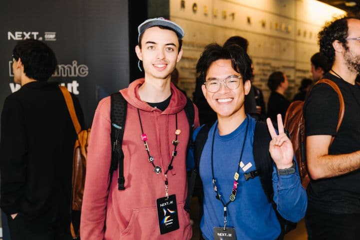 two people standing next to each other at an event