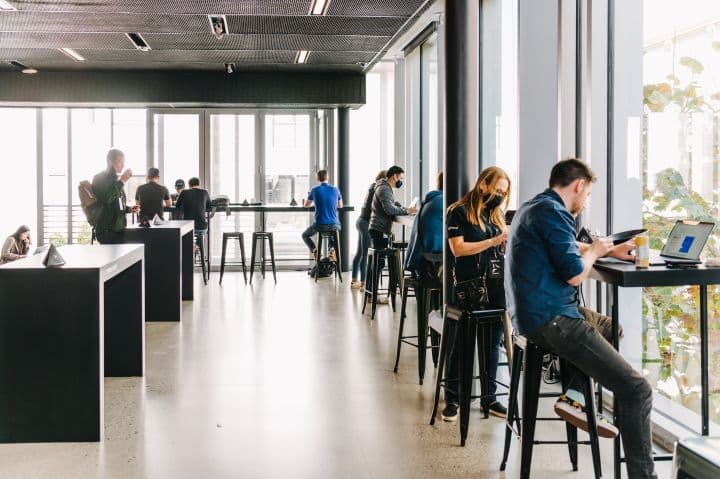 a group of people sitting at tables in a restaurant