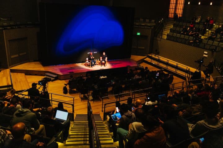 a group of people sitting on top of a stage