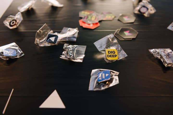 a table topped with lots of different pins