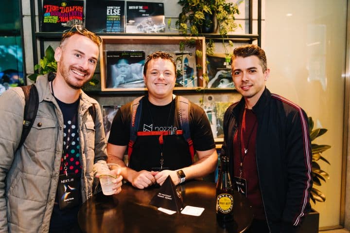 a group of three men standing next to each other