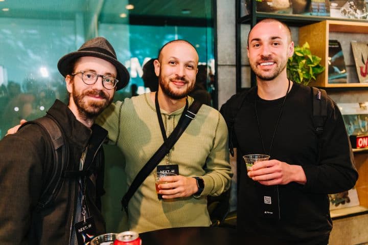 a group of three men standing next to each other