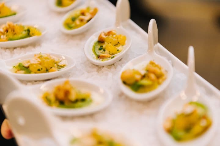 a tray filled with small white bowls filled with food