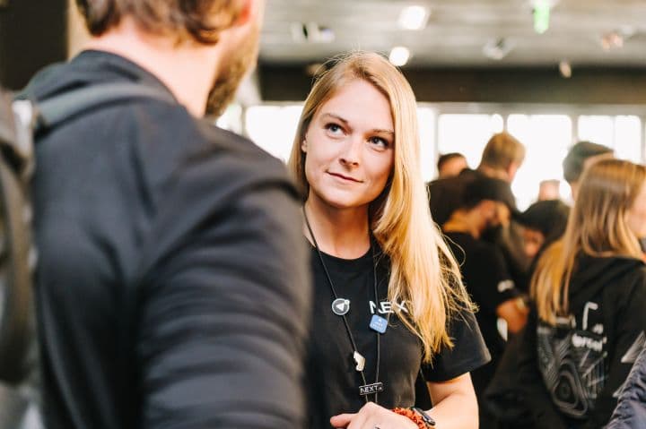 a woman standing next to a man in a black shirt