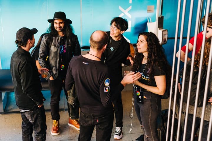 a group of people standing around each other