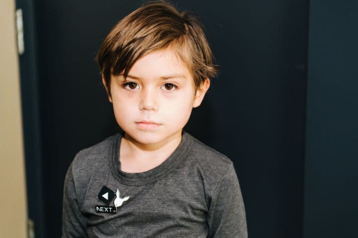 a young boy is posing for a picture