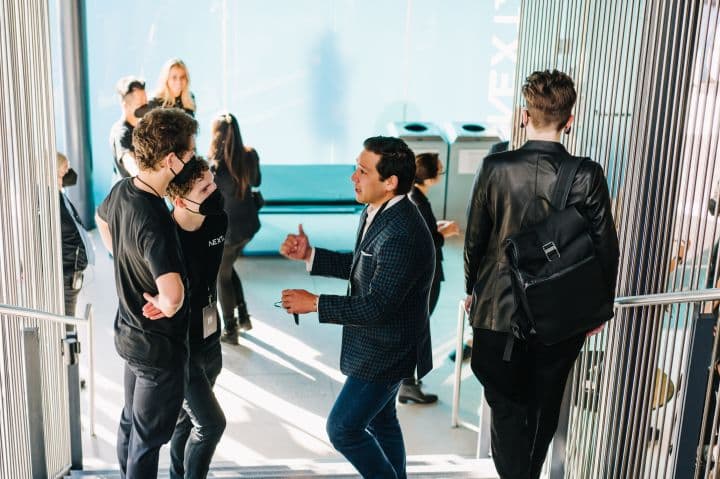 a group of people standing around a building