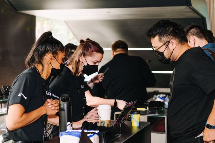 a group of people standing around a counter