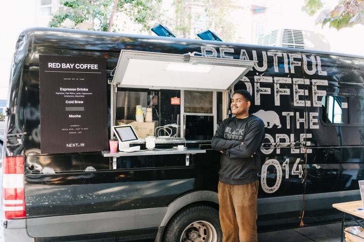 a man standing in front of a food truck