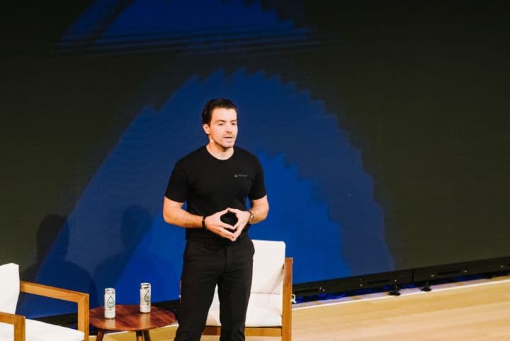 a man standing on a stage with a remote in his hand