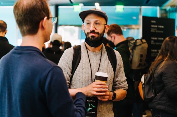 a man with a beard holding a cup of coffee