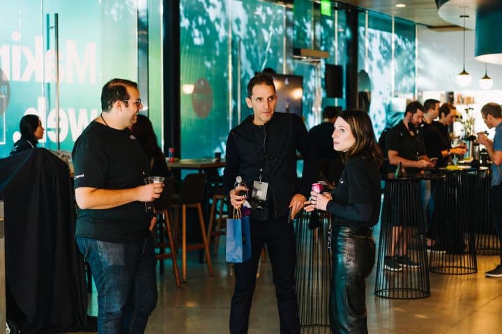 a group of people standing around a bar