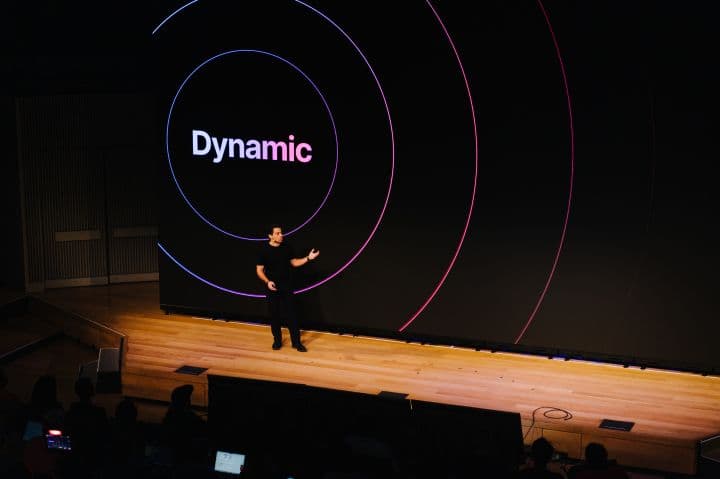 a man standing on top of a stage in front of a crowd