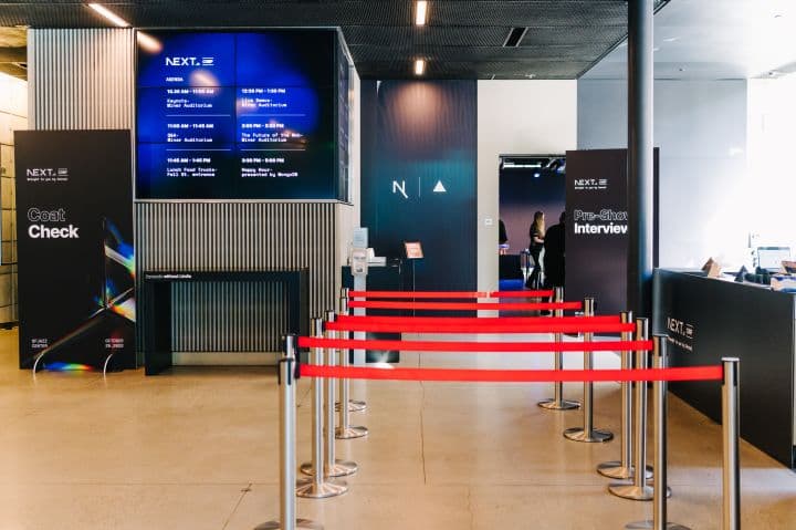 a row of red barriers in front of a check in counter