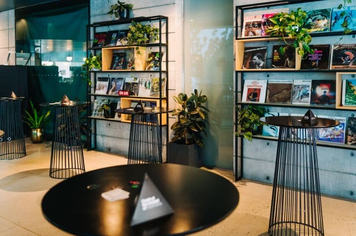 a room filled with lots of books and plants