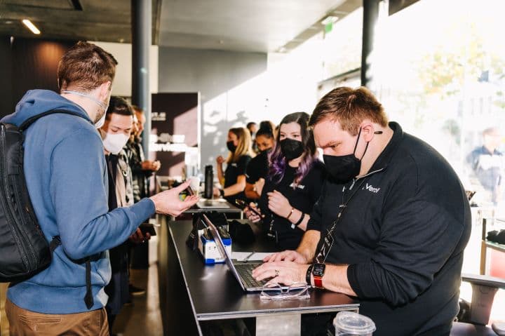 a group of people standing around a counter