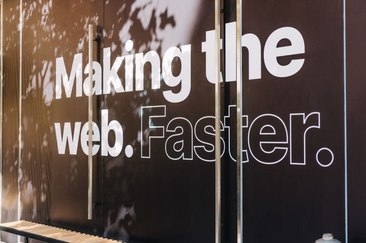 a sign on the side of a building that says making the web faster
