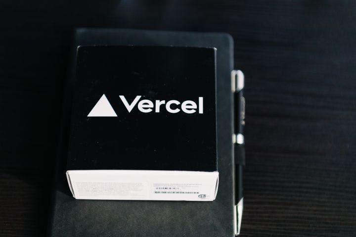 a black notebook with a vercel logo on it