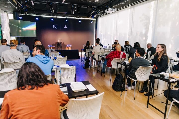 a group of people sitting at tables in a room