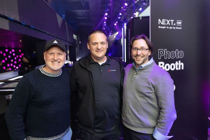 a group of three men standing next to each other