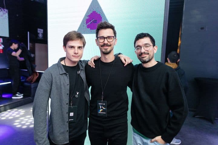 a group of three men standing next to each other