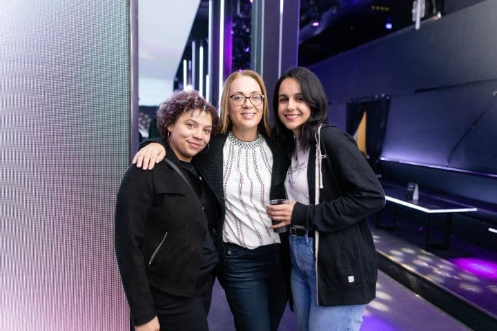 a group of three women standing next to each other