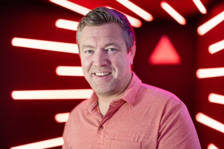 a man standing in front of a red light