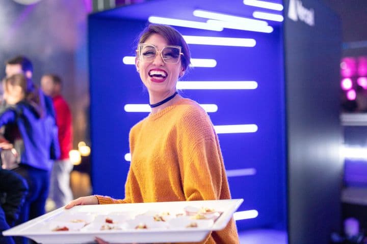 a woman is holding a tray of food