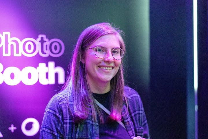 a woman with glasses is smiling for the camera