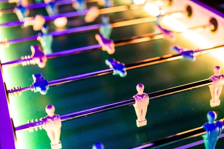 a close up of a foosball table with people on it