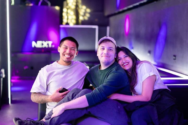 a man and two women sitting on a couch