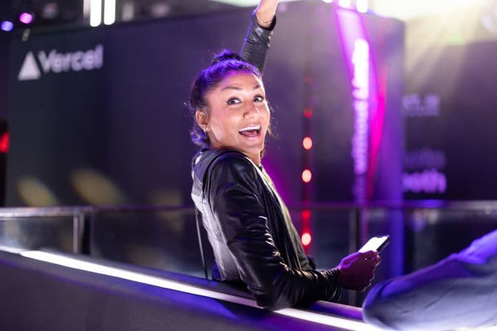 a woman in a black leather jacket sitting on a bench