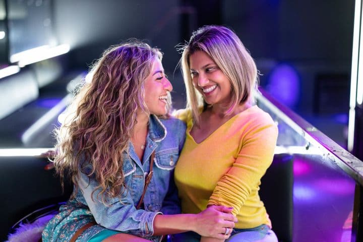 a couple of women sitting next to each other