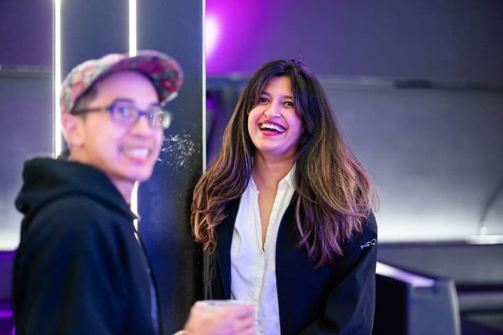 a woman standing next to a man in a room