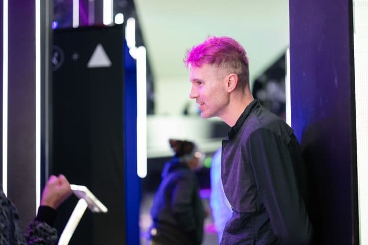 a man with pink hair standing next to another man