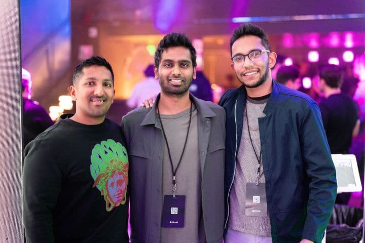 a group of three men standing next to each other