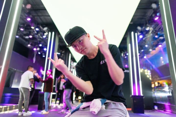 a man sitting on a stool in front of a stage