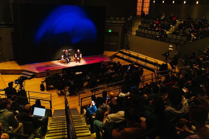 a group of people sitting on top of a stage