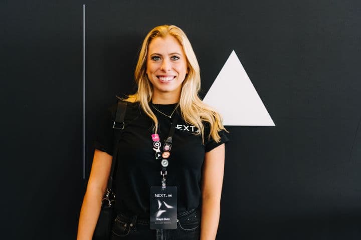 a woman standing in front of a black wall